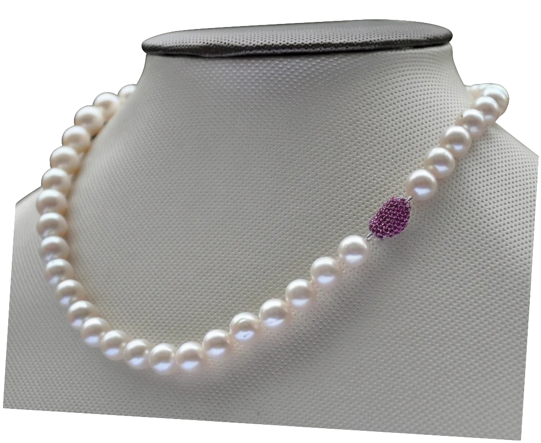 White round pearl necklace displayed on a fabric bust with a distinct textured fuchsia pavé-style decorative bead integrated into the strand.